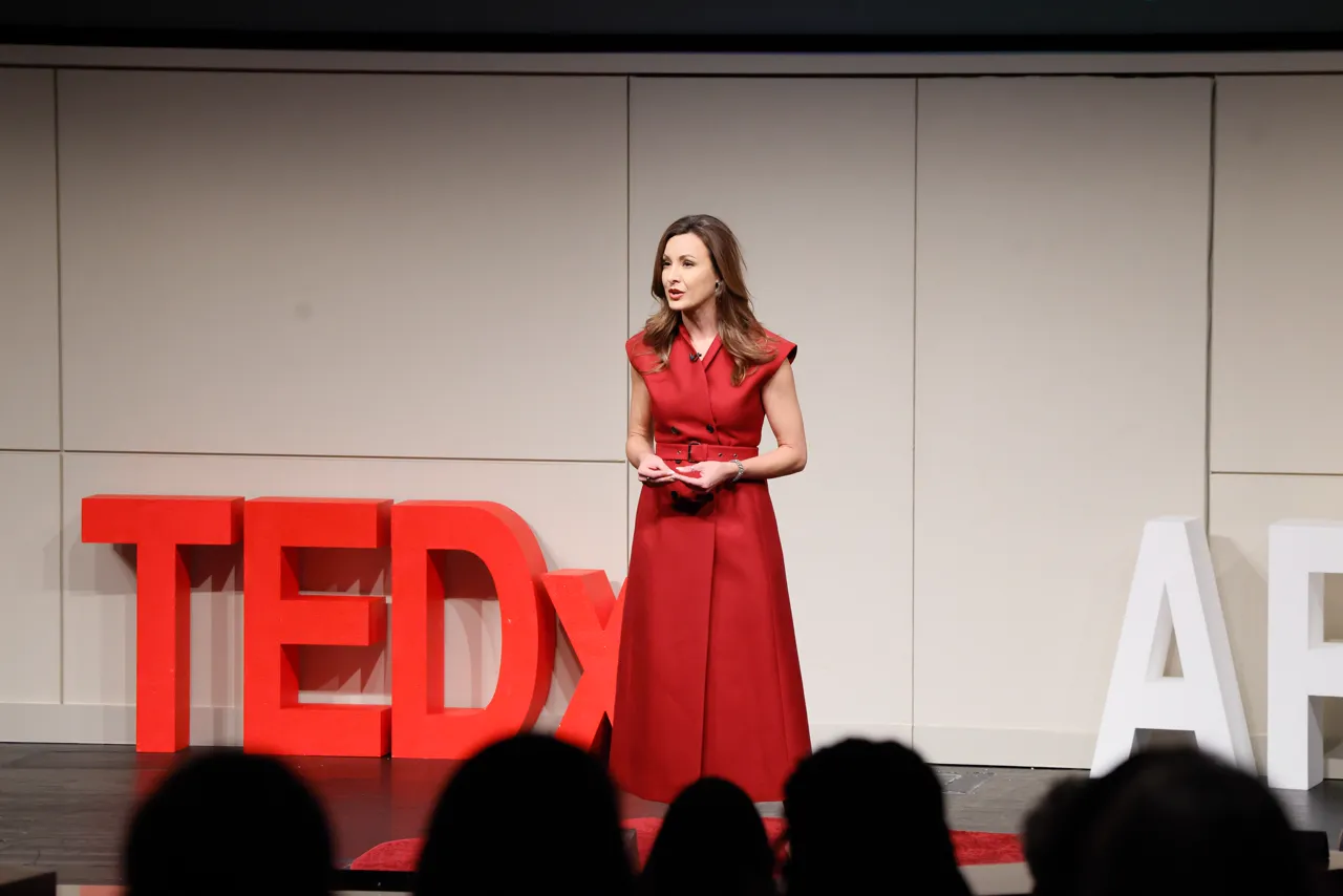 Dr. Rebecca Troy speaking on the TEDxApex stage